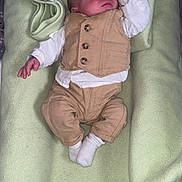 Aïden participe au concours pour gagner de l'argent avec cette photo : baby, sleeping, infant, blanket, clothing, vest, pants, white_socks, soft_texture, indoors, cute, resting, newborn, child, portrait, peaceful, small_hands, nap, cozy, sleepwear
