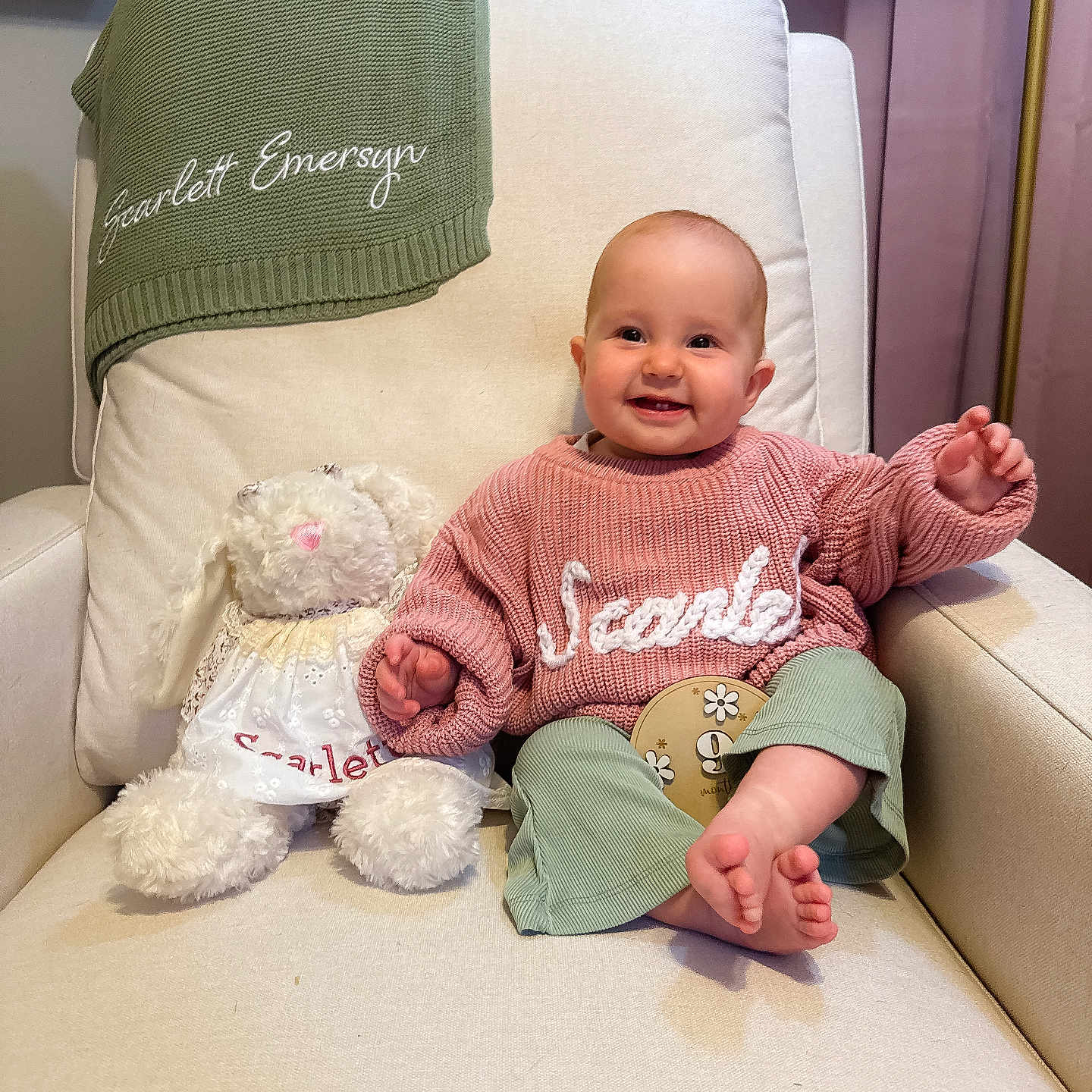 Scarlett is registered to the contest to win money with this photo: armchair, baby, blanket, child, clothing, cozy, curtains, cute, footwear, furniture, happy, home_decor, indoor, knitwear, person, plant, portrait, smiling, stuffed_animal, toy
