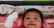 Jamie Lynn is registered to the contest to win money with this photo: baby, infant, blanket, mitten, red_shirt, smiling, face, lying_down, indoors, cushion, knit, soft_texture, happy, person, child, closeup, portrait, cozy, home, warning_label