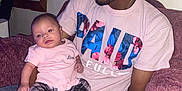 Samantha is registered to the contest to win money with this photo: baby, cap, casual, child, comfort, couch, family, holding, home, indoor, love, man, pants, person, pink, plaid, portrait, relaxed, seated, shirt