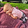 Samantha is registered to the contest to win money with this photo: baby, blanket, grass, outdoor, car, wheel, pink_clothing, patterned_pants, hand, face, infant, cute, plush, toddler, chewing, nature, soft_texture, lying_down, curious, child