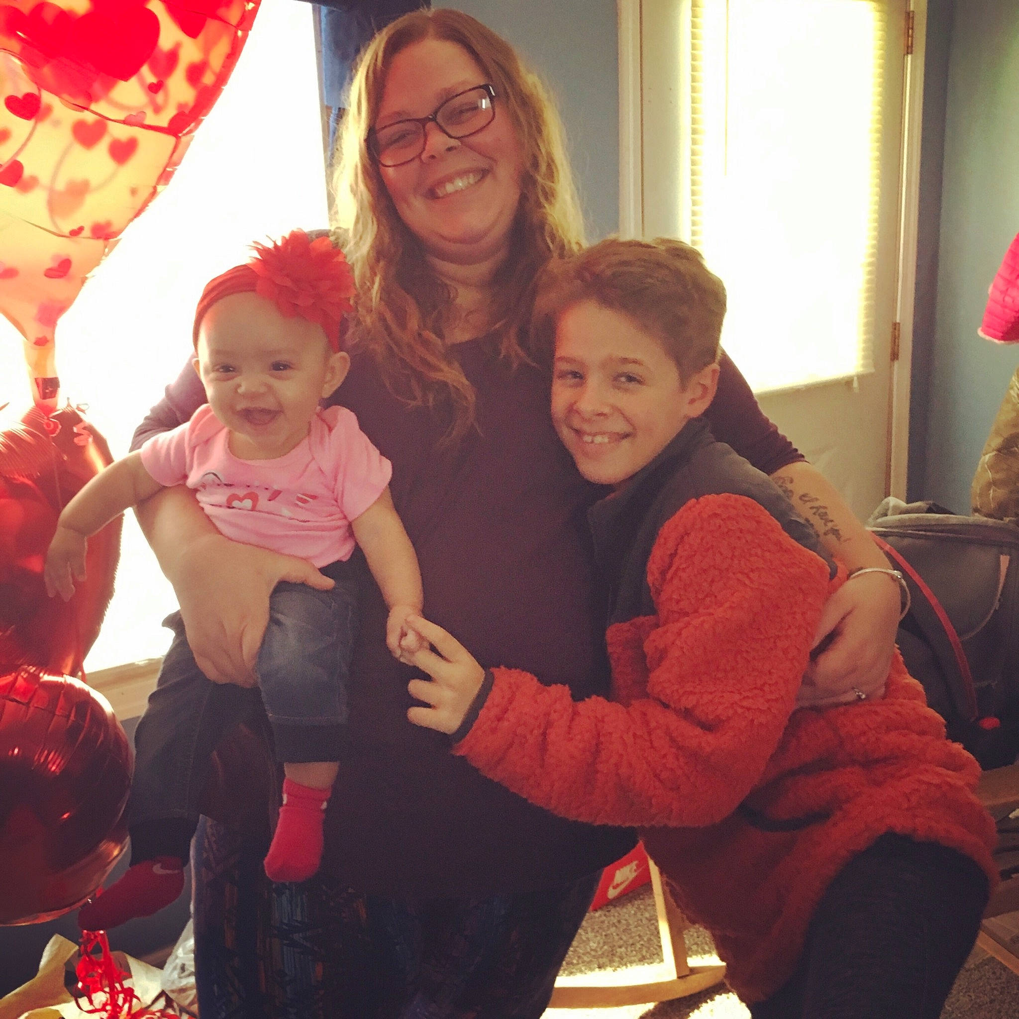 Kiera is registered to the contest to win money with this photo: child, christmas, christmas_eve, event, face, family, happy, head, holiday, joy, party, people, person, play, red, room, skin, smile, standing, toddler