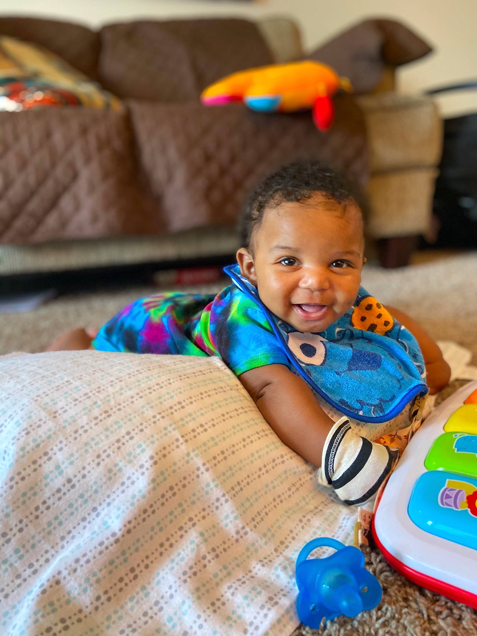 Charles joined the competition — help win amazing prizes! baby, baby_toddler_clothing, child, comfort, couch, event, flooring, fun, happy, joy, leisure, orange, person, play, room, sitting, skin, smile, t_shirt, toddler