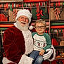 santa_claus, child, glasses, christmas, holiday, gift_wrap, tree, decorations, smile, festive, red_suit, white_beard, toy_train, shelf, young_boy, indoor, portrait, happy, winter_clothing, celebration