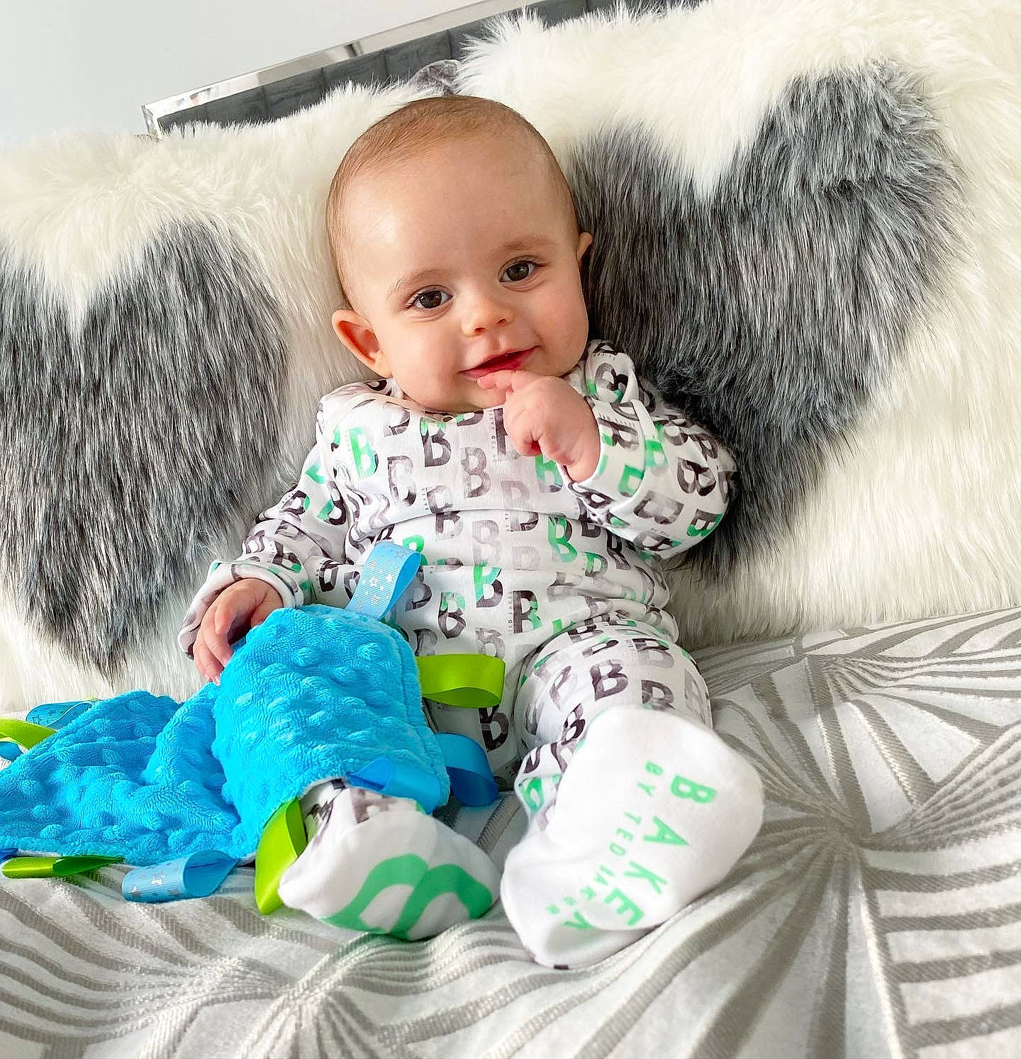 Finnley is registered to the contest to win money with this photo: baby, baby_products, baby_toddler_clothing, baby_toys, child, comfort, fur, happy, linens, outerwear, pattern, person, play, sitting, sleeve, smile, stuffed_toy, t_shirt, toddler, toy