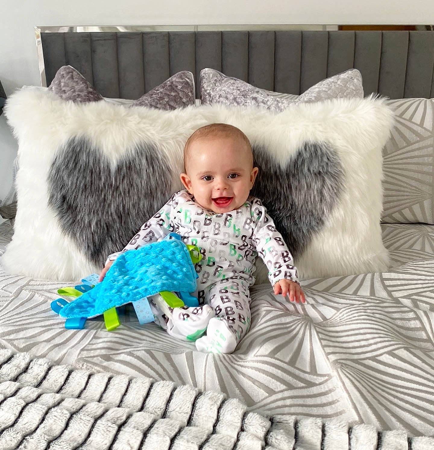 Finnley is registered to the contest to win money with this photo: baby, baby_sleeping, baby_toddler_clothing, comfort, couch, eye, face, happy, head, joy, linens, mammal, outerwear, person, product, sitting, sleeve, smile, textile, throw_pillow