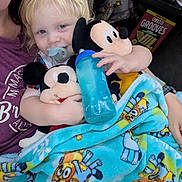 Colt joined the competition — help win amazing prizes! blanket, blonde_hair, cartoon_characters, casual, cheez_it_grooves, child, cozy, cuddling, furniture, home, indoor, mickey_mouse, pacifier, person, plush_toy, relaxed, sippy_cup, smiling, snack_box, toddler