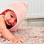baby, child, pink_towel, carpet, crawling, smile, happy, face, hand, indoor, cute, skin, head, infant, young, towel, floor, portrait, playful, warm