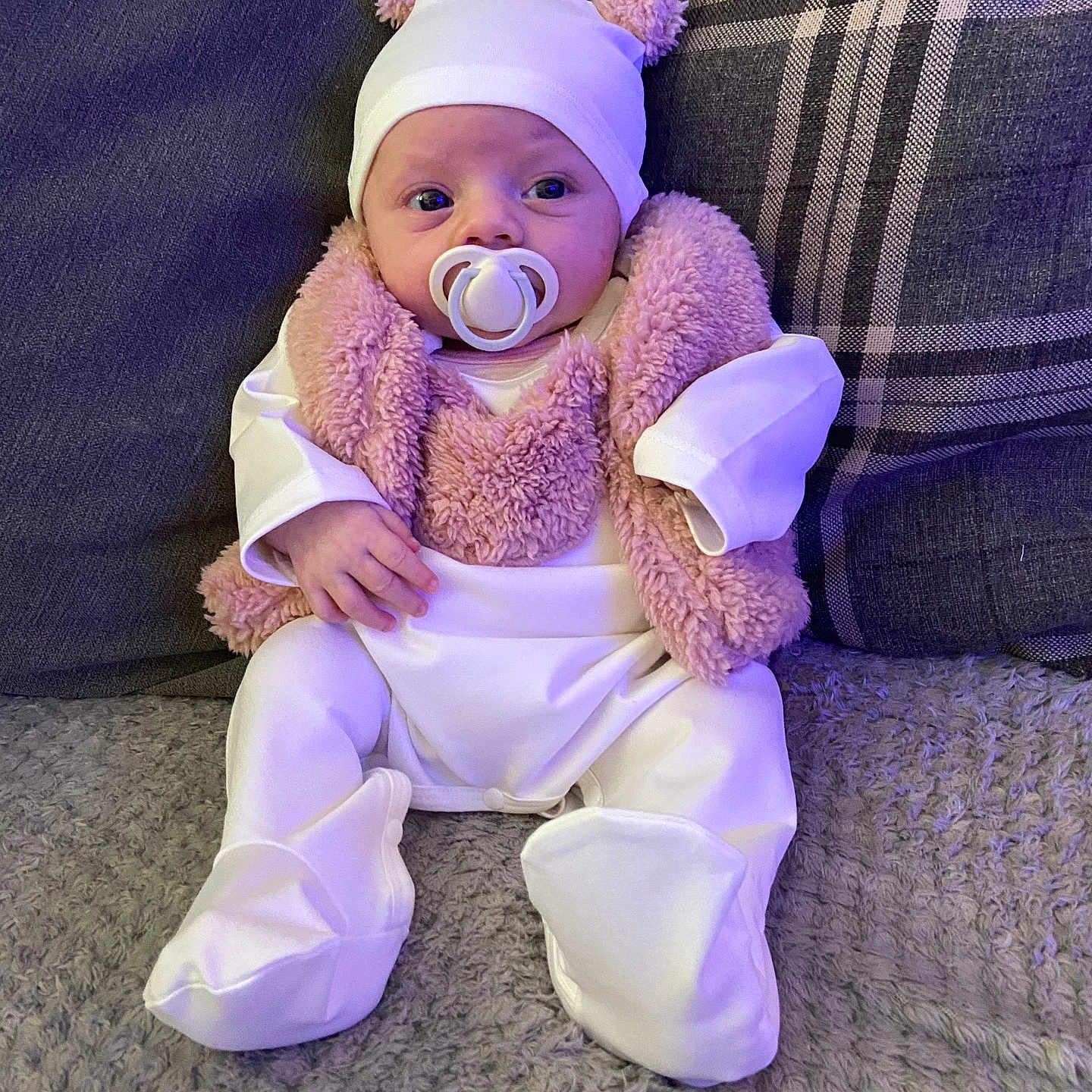Sienna-Rae is registered to the contest to win money with this photo: baby, blanket, bonnet, cap, clothing, couch, cushion, face, furniture, hat, head, homedecor, pants, person, photography, portrait, purple, sitting, sleeve, yawning