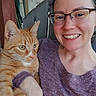 Pineapple joined the competition — help win amazing prizes! animal, cat, closeup, face, fur, furniture, glasses, happy, holding, home, human, indoor, orange_tabby, person, pet, portrait, purple_shirt, relaxed, smiling, whiskers
