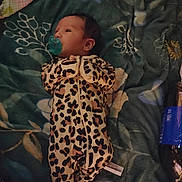 Adalyn is registered to the contest to win money with this photo: baby, infant, pacifier, onesie, leopard_print, blanket, floral_pattern, bottle, blue, lying_down, bed, sleepwear, cute, newborn, child, person, cozy, indoor, soft, resting