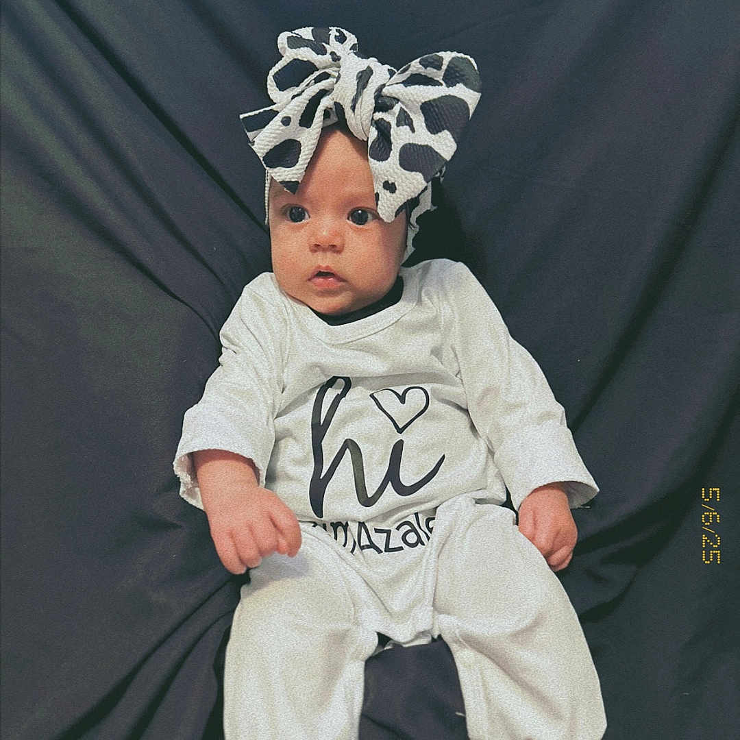Azalea joined the competition — help win amazing prizes! accessories, baby, bodypart, bonnet, cap, clothing, costume, face, finger, hand, hat, head, newborn, pants, people, person, photography, portrait, sitting, t_shirt