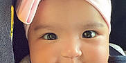 Eliana joined the competition — help win amazing prizes! adorable, baby, baby_girl, car_seat, child, chubby_cheeks, closeup, clothing, cute, face, happy, headband, indoor, infant, person, pink, portrait, seatbelt, smile, young