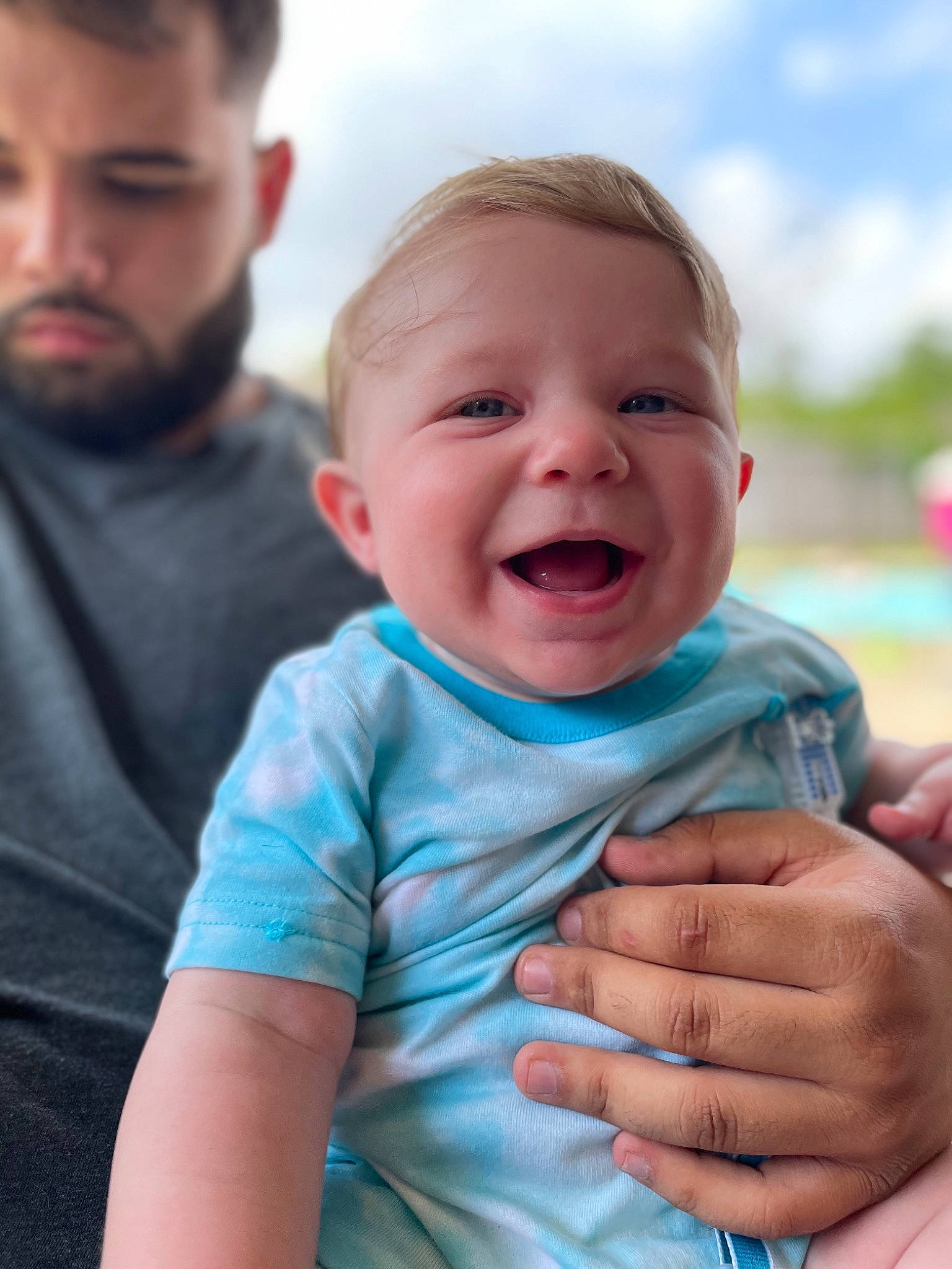 Garrett joined the competition — help win amazing prizes! baby, blue, cheek, eye, face, facial_expression, fun, gesture, grass, happy, head, human, interaction, mouth, person, photograph, skin, sky, sleeve, smile