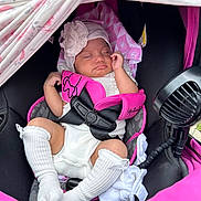 Zamora joined the competition — help win amazing prizes! baby, sleeping, car_seat, pink, white_clothing, hat, blanket, socks, infant, child, resting, cute, comfort, safety_harness, fan, soft, relaxed, indoors, toddler, peaceful