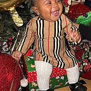 Jream joined the competition — help win amazing prizes! baby, child, smiling, holiday, gift_box, balloon, striped_clothing, white_tights, black_shoes, floor, decorations, christmas, festive, indoor, person, cute, happy, celebration, portrait, sitting