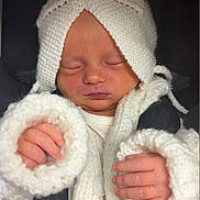 Quinzella-Bambi is registered to the contest to win money with this photo: baby, newborn, sleeping, knitted_hat, knitted_sweater, pacifier, car_seat, infant, child, closeup, cute, peaceful, cozy, warm_clothing, hands, face, seatbelt, portrait, indoors, soft_texture