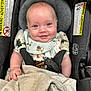 Jesiah is registered to the contest to win money with this photo: baby, infant, car_seat, smile, blue_eyes, blanket, bib, clothing, child, seat_belt, happy, cute, indoor, sitting, person, head, face, safety, comfort, closeup