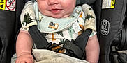 Jesiah is registered to the contest to win money with this photo: baby, infant, car_seat, blanket, smile, blue_eyes, clothing, buckle, safety, child, cute, indoor, portrait, happy, seat_belt, fabric, soft, head_support, person, closeup