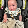 baby, infant, car_seat, blanket, smile, blue_eyes, clothing, buckle, safety, child, cute, indoor, portrait, happy, seat_belt, fabric, soft, head_support, person, closeup