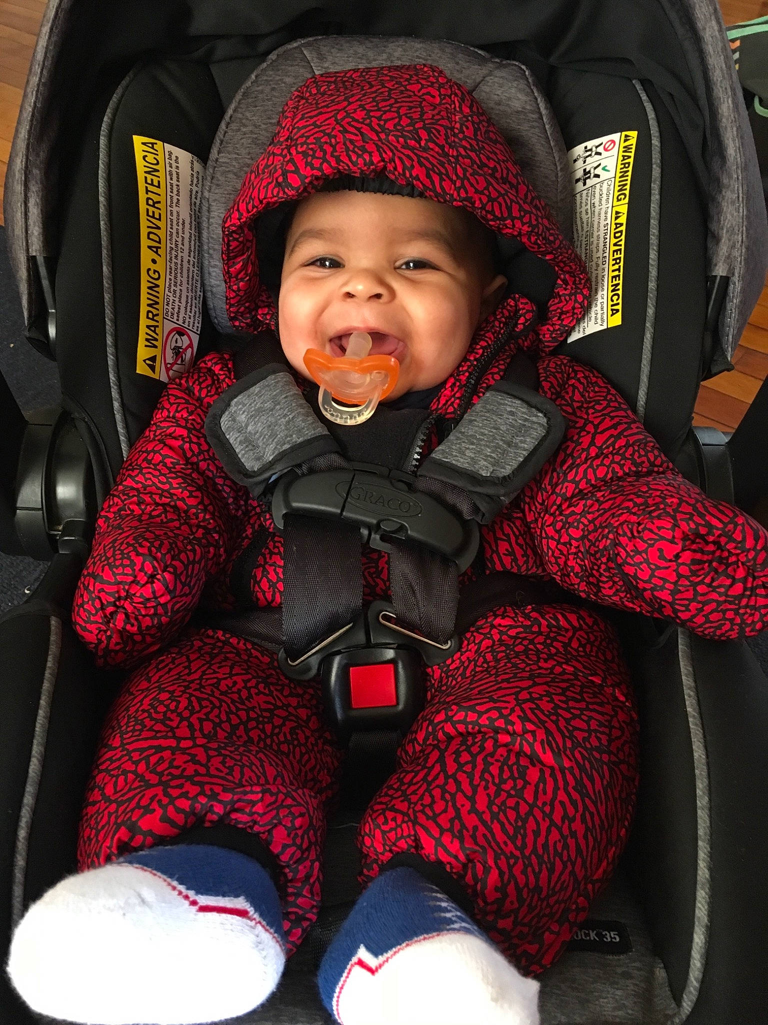 Kaileb joined the competition — help win amazing prizes! auto_part, baby, baby_carriage, baby_in_car_seat, baby_products, car_seat, child, fun, headgear, knit_cap, knitting, outerwear, person, personal_protective_equipment, product, red, smile, toddler, wool