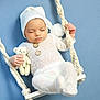 baby, infant, sleeping, teddy_bear, white_clothing, knit_hat, swing, rope, blue_background, soft_texture, cute, peaceful, hand, footwear, portrait, child, indoors, toy, calm, resting