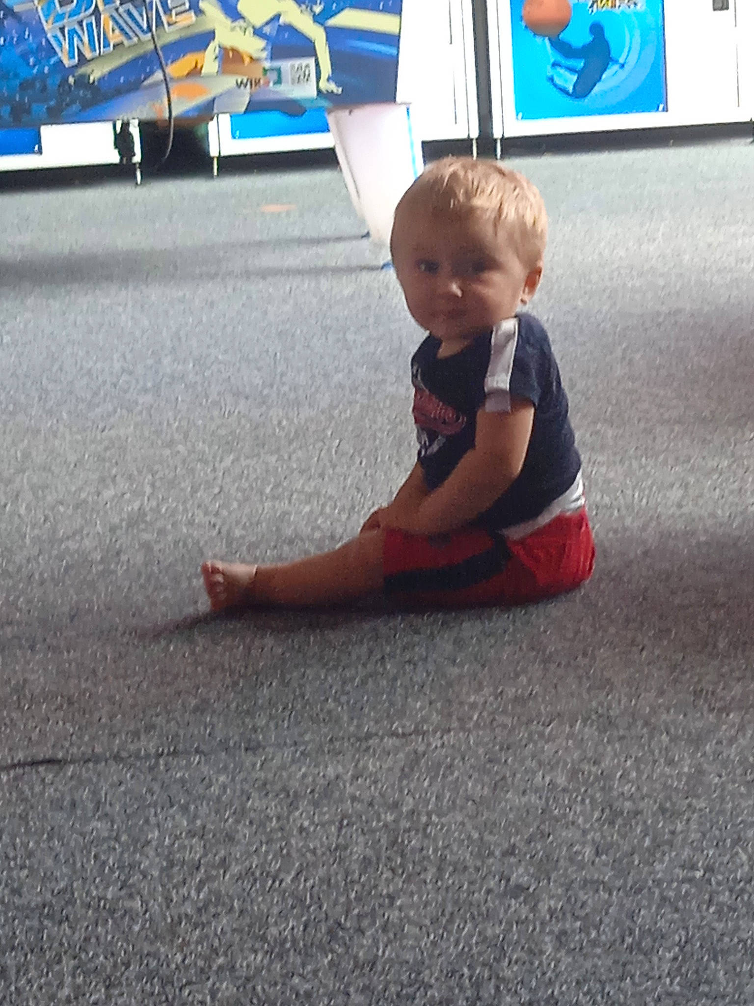 Diego a rejoint le concours — aidez-le/la à gagner de superbes lots ! asphalt, baby, baby_toddler_clothing, blue, child, city, flooring, foot, fun, grass, human_leg, knee, leg, person, public_space, recreation, road_surface, sitting, t_shirt, toddler