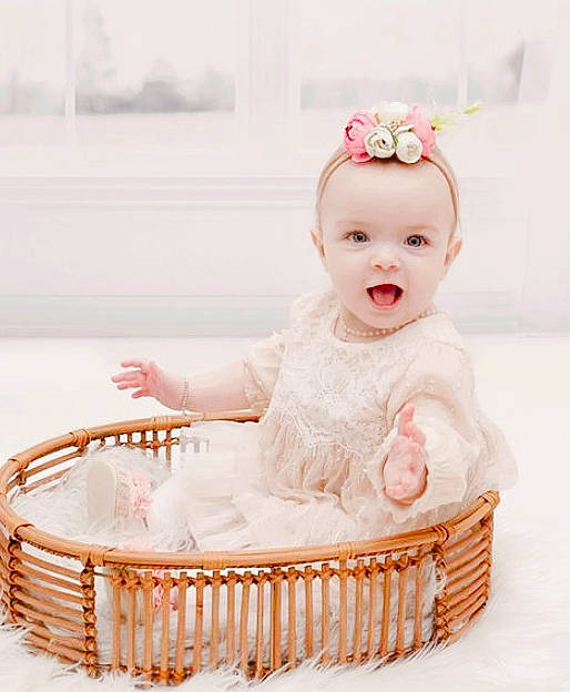 Korra joined the competition — help win amazing prizes! baby, baby_toddler_clothing, basket, child, embellishment, event, fashion_accessory, hair_accessory, happy, headband, headpiece, magenta, peach, person, pink, product, sitting, sleeve, smile, storage_basket