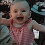 Kora is registered to the contest to win money with this photo: baby, child, smiling, pink_clothing, striped, butterfly_patch, happy, indoor, person, hand, holding, laptop, clothes, furniture, table, cup, bottle, bracelet, face, portrait