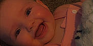 Kora joined the competition — help win amazing prizes! baby, smiling, infant, happy, face, pink_clothing, blanket, carpet, cute, child, skin, tongue, button, eyes, head, cheeks, person, indoors, baby_girl, soft_toy