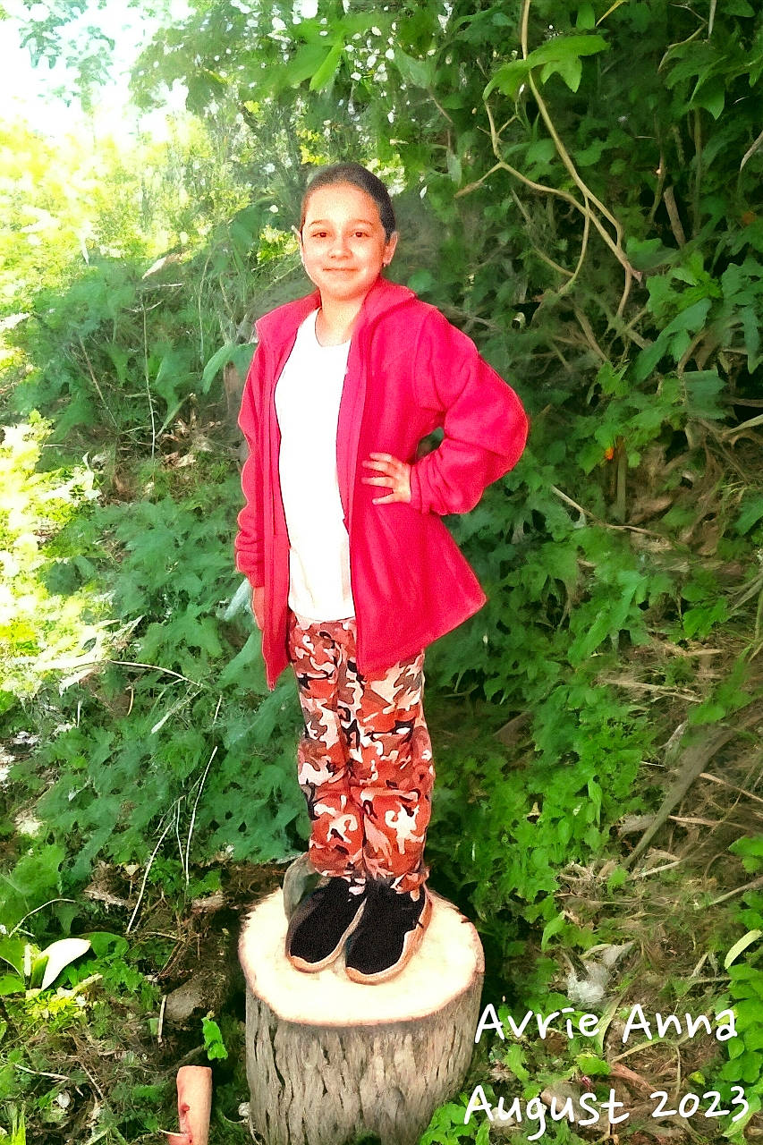 Avrie is registered to the contest to win money with this photo: boot, botany, fashion_design, formal_wear, grass, happy, joy, lawn_ornament, magenta, pattern, people_in_nature, person, plant, sandal, shrub, sleeve, smile, soil, terrestrial_plant, thigh