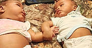 My'Drevious Bell joined the competition — help win amazing prizes! baby, infant, holding_hands, blanket, bed, diaper, clothing, person, indoor, couch, remote_control, legs, relaxation, skin, cute, toddler, child, home, family, resting