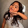 Leiza is registered to the contest to win money with this photo: child, girl, smile, pose, dress, white_dress, pearls, bow, hair, long_hair, curly_hair, portrait, happy, cute, fashion, accessory, necklace, indoor, studio, person