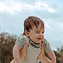 Tatum is registered to the contest to win money with this photo: baby, child, smile, happy, hands, outdoor, sky, cloudy, nature, portrait, infant, cute, playful, person, clothing, short_sleeves, holding, face, head, young