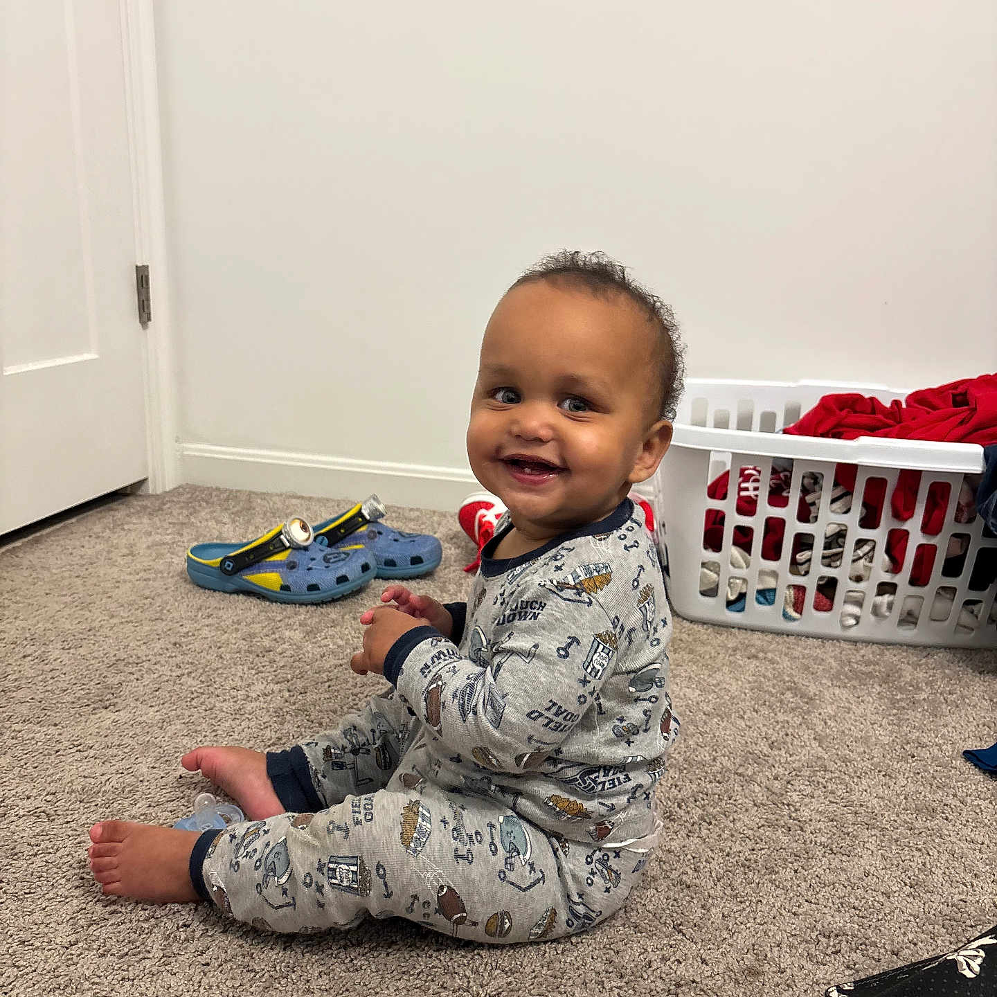 Giancarlo joined the competition — help win amazing prizes! baby, carpet, casual, child, clothing, face, floor, hair, happy, home, indoor, infant, laundry_basket, pacifier, pajamas, person, shoe, sitting, smile, toys
