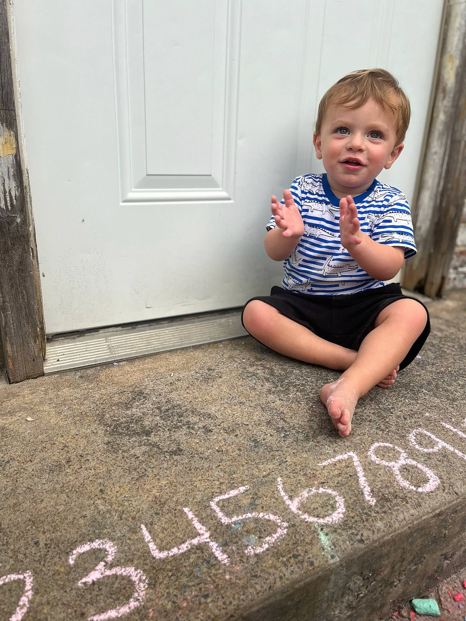 Owen joined the competition — help win amazing prizes! asphalt, baby_toddler_clothing, chalk, child, concrete, flash_photography, floor, flooring, font, grass, handwriting, happy, human_leg, person, road_surface, sidewalk, standing, t_shirt, toddler, wall