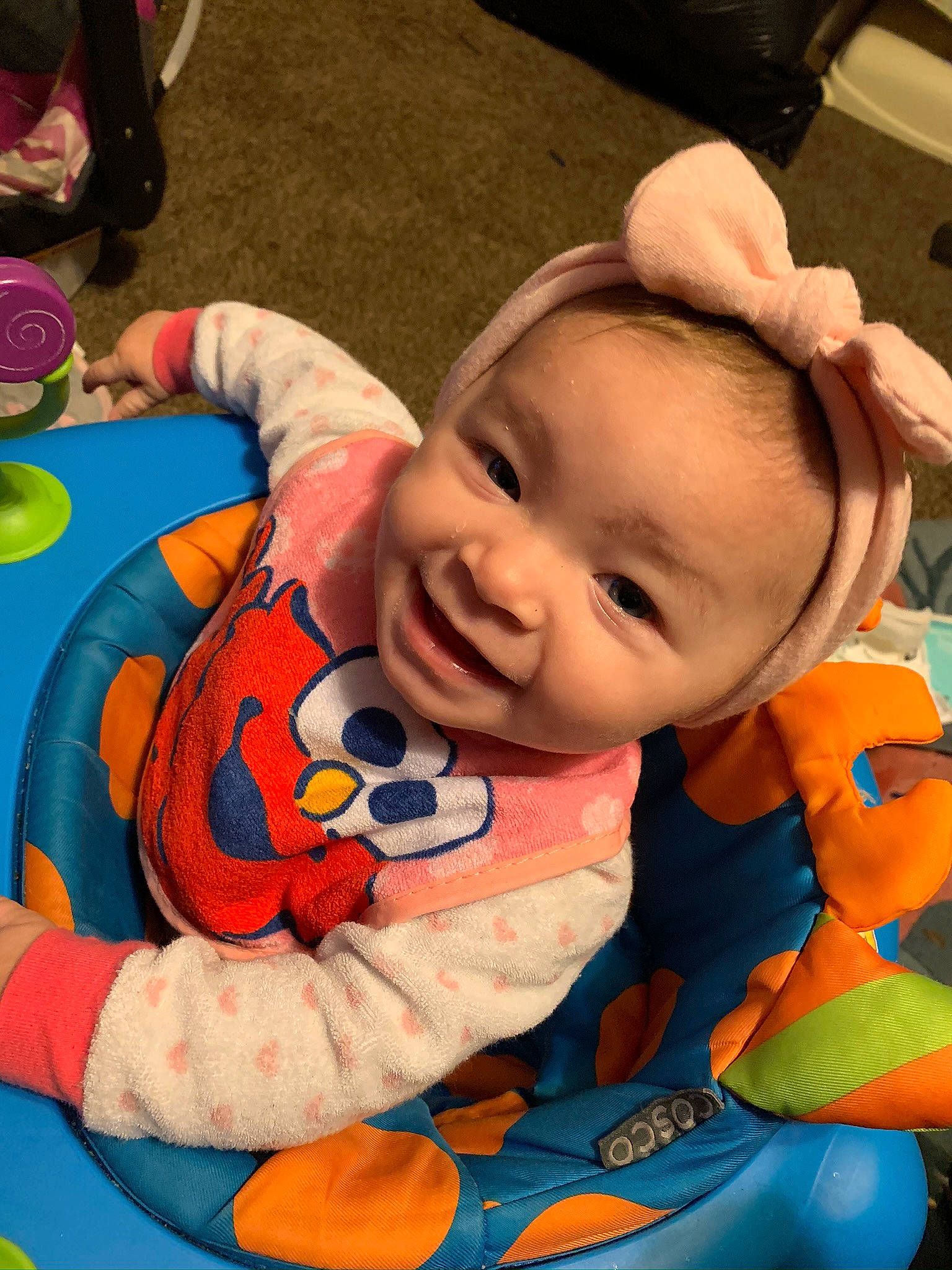 Astrid is registered to the contest to win money with this photo: baby, baby_products, baby_toddler_clothing, cheek, child, comfort, face, facial_expression, fun, happy, head, leisure, mouth, orange, person, sitting, skin, smile, snapshot, textile