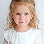 child, girl, portrait, blonde_hair, white_dress, smile, face, hair_clip, young, innocent, soft_lighting, close_up, cute, childhood, elegant, studio, person, fashion, pretty, youth