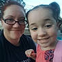 Lindsay is registered to the contest to win money with this photo: woman, child, girl, smiling, outdoor, glasses, pigtails, backpack, pink, tshirt, portrait, selfie, person, tree, sky, power_lines, casual, happy, daylight, face