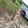 child, girl, outdoor, dress, boots, car, dirt, grass, tree, tire, curious, walking, nature, face, pigtails, young, casual, daylight, sidewalk, person