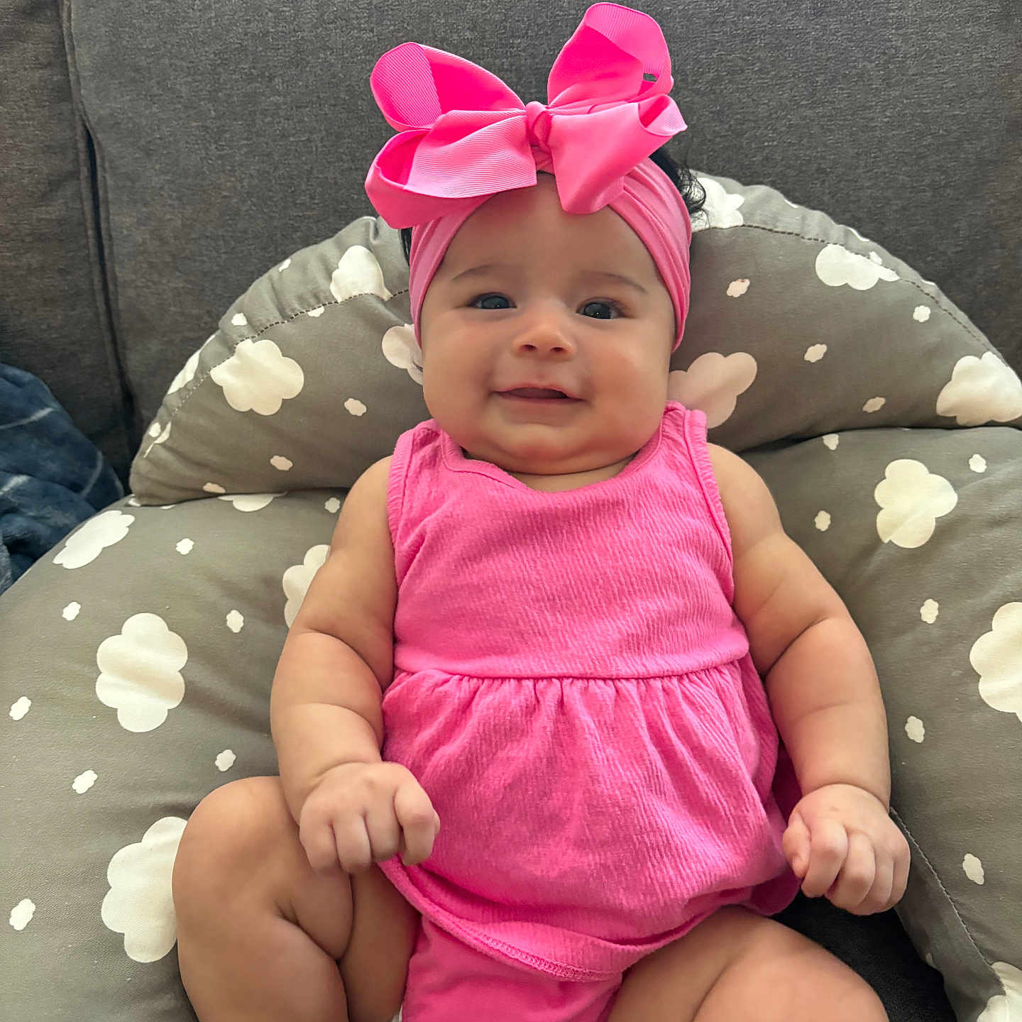 Aubree is registered to the contest to win money with this photo: accessories, baby, cap, clothing, couch, cushion, dress, face, furniture, happy, hat, head, headband, homedecor, newborn, person, photography, portrait, sitting, smile