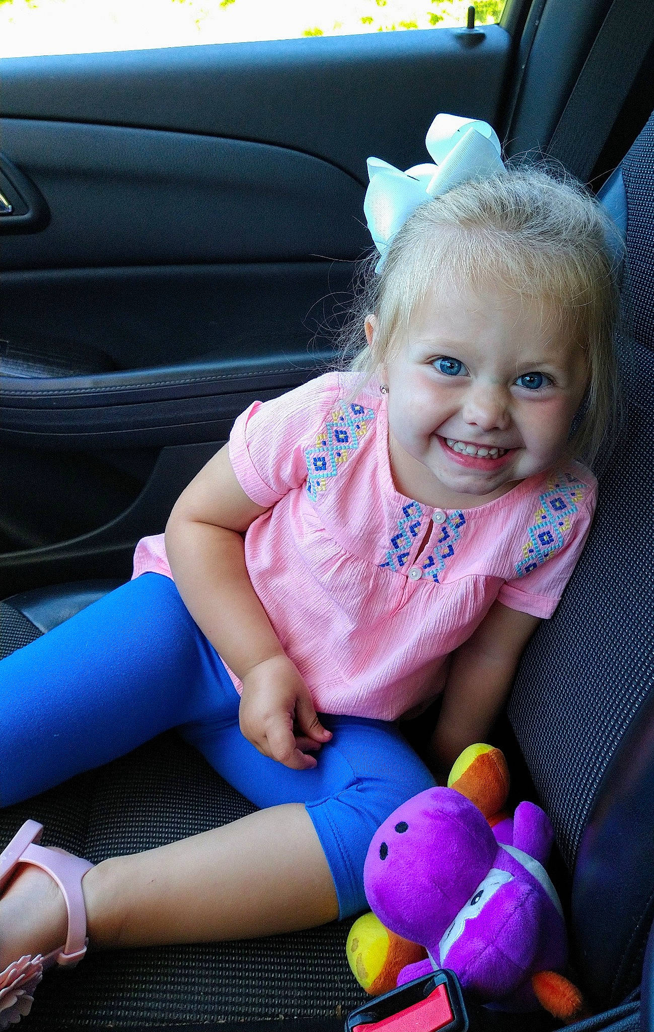 Cambrie is registered to the contest to win money with this photo: baby, blond, car, car_seat, child, ear, eye, joy, person, pink, play, purple, sitting, skin, smile, toddler, toy, vacation, vehicle, violet