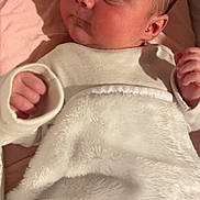 Shelby joined the competition — help win amazing prizes! baby, infant, blanket, white_clothing, lying_down, fist, face, skin, head, newborn, soft_texture, cozy, indoors, sleepwear, cute, child, expression, person, portrait, resting