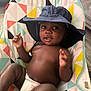 baby, child, hat, diaper, seat, colorful, pattern, indoor, infant, cute, smile, face, hand, relaxing, young, playful, skin, person, comfort, headwear