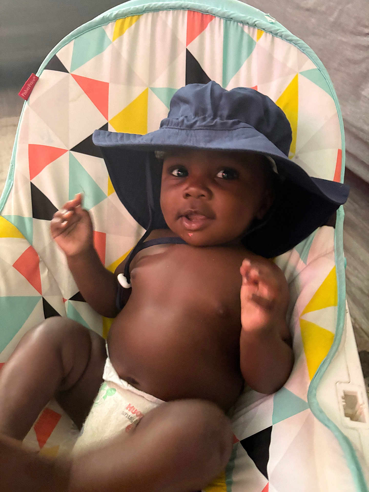 Josias joined the competition — help win amazing prizes! baby, child, hat, diaper, seat, colorful, pattern, indoor, infant, cute, smile, face, hand, relaxing, young, playful, skin, person, comfort, headwear