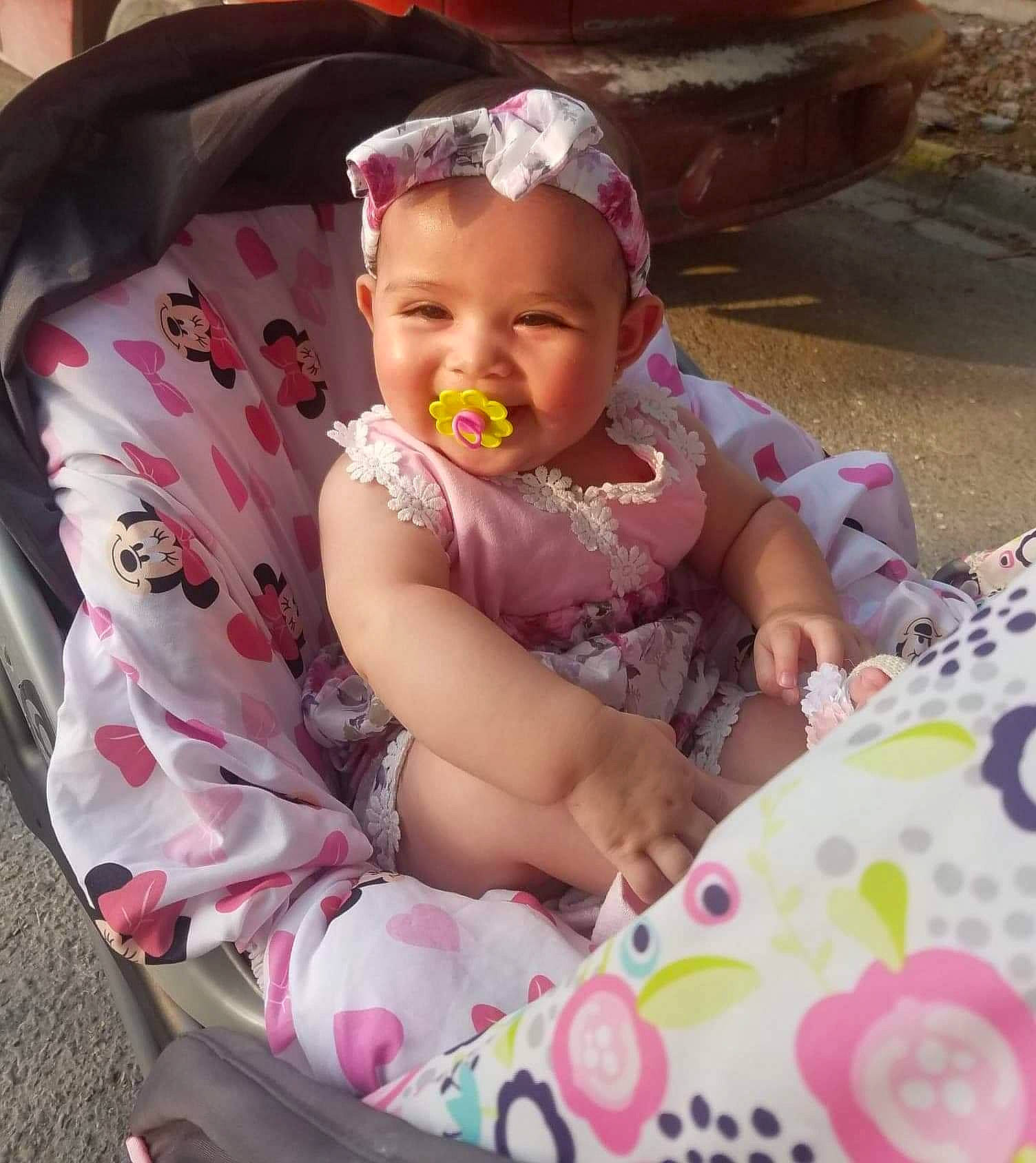 Yudith joined the competition — help win amazing prizes! baby, baby_products, baby_toddler_clothing, child, comfort, eye, fashion_accessory, fun, grass, happy, head, iris, lap, pattern, person, pink, sitting, skin, smile, sunglasses