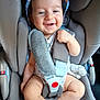 baby, car_seat, smiling, child, infant, safety_harness, hat, cute, seat_belt, clothing, indoor, person, happy, young_child, baby_leg, baby_feet, car_interior, soft, comfort, seat