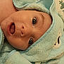 baby, baby_clothing, blue, child, closeup, cute, expression, eyelashes, eyes, fabric, face, head, hooded_towel, indoor, infant, mouth, person, portrait, skin, soft_texture