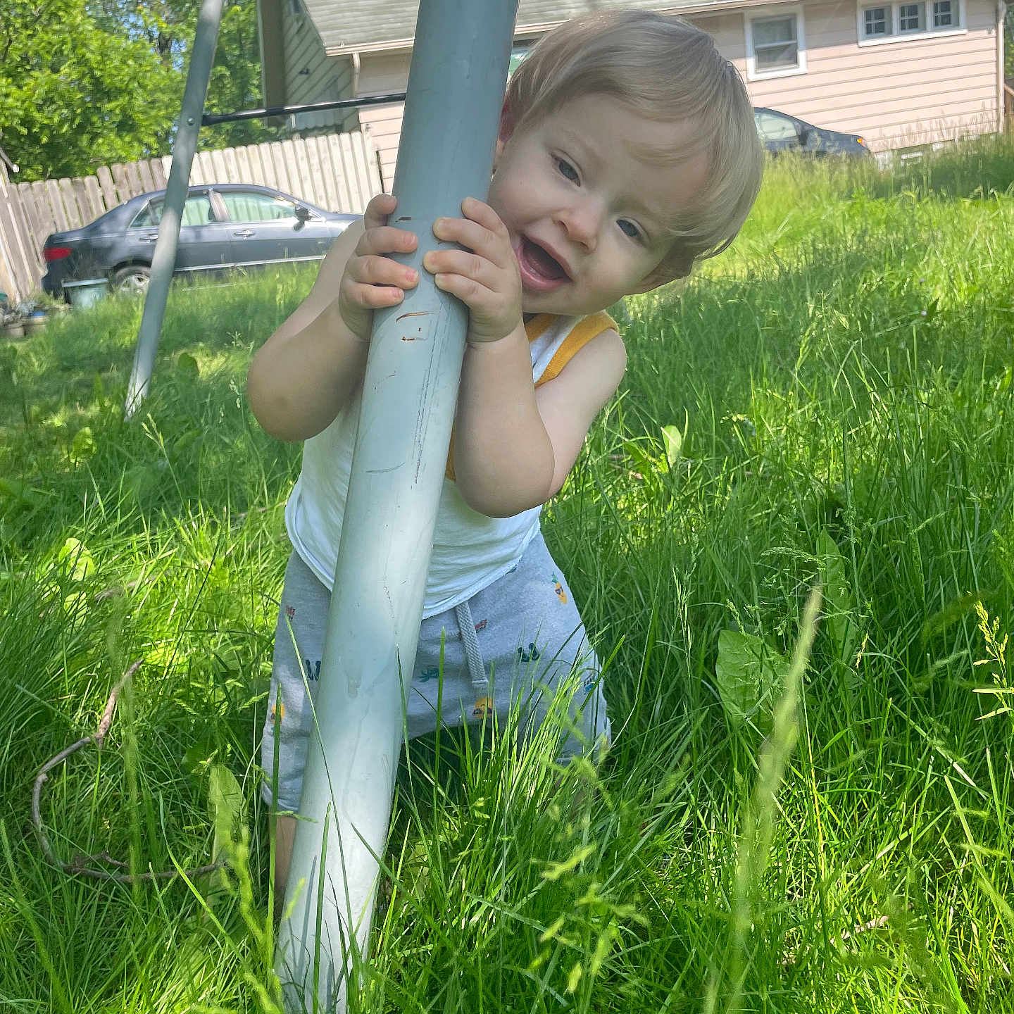 Grayson Cuttler joined the competition — help win amazing prizes! backyard, car, casual_clothing, child, daylight, fun, grass, greenery, happy, house, nature, outdoor, person, playground, pole, portrait, smiling, summer, toddler, young_child