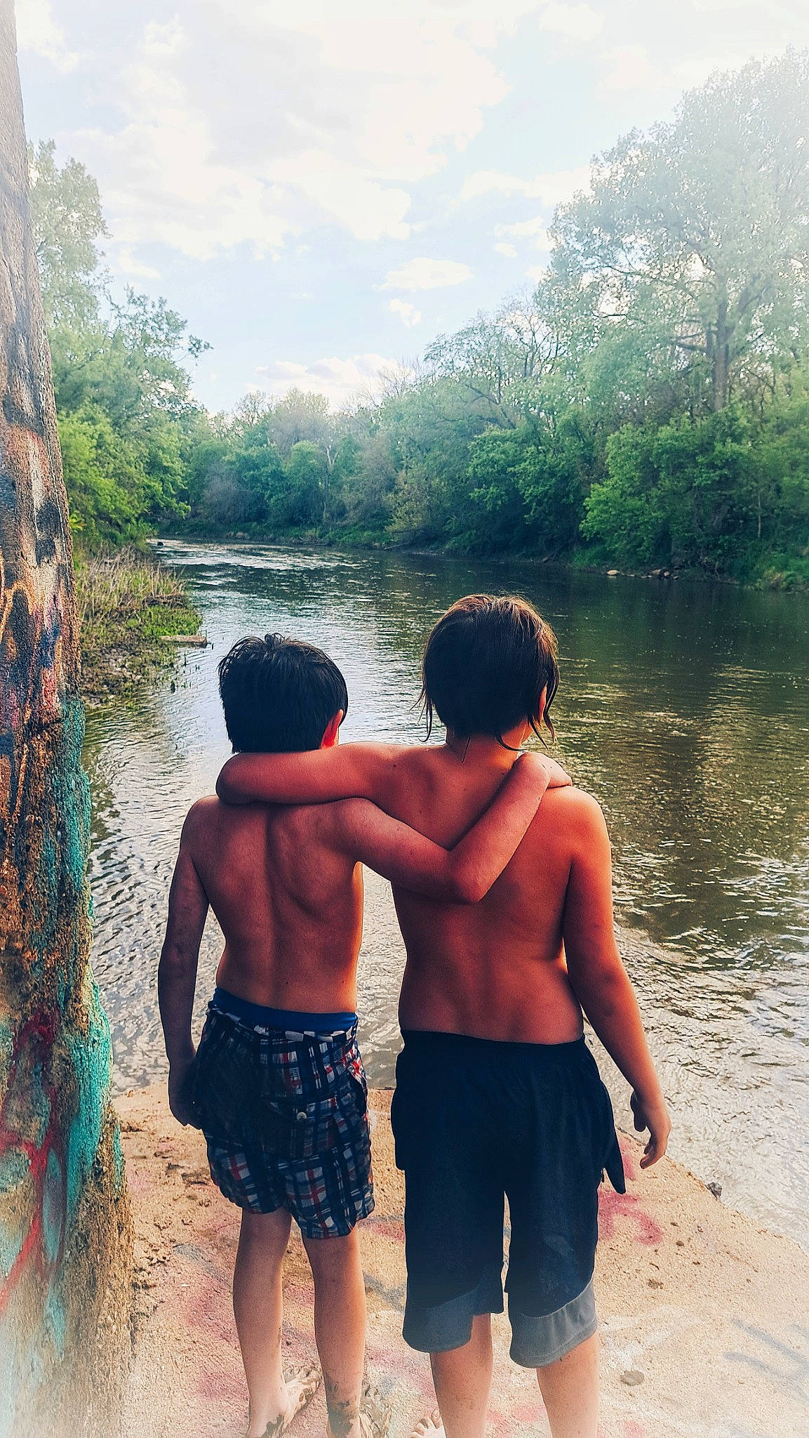 Kayleb is registered to the contest to win money with this photo: adaptation, body_of_water, cool, fun, gesture, happy, lake, leisure, light, morning, nature, people_in_nature, person, shorts, sky, summer, sunlight, travel, tree, trunks